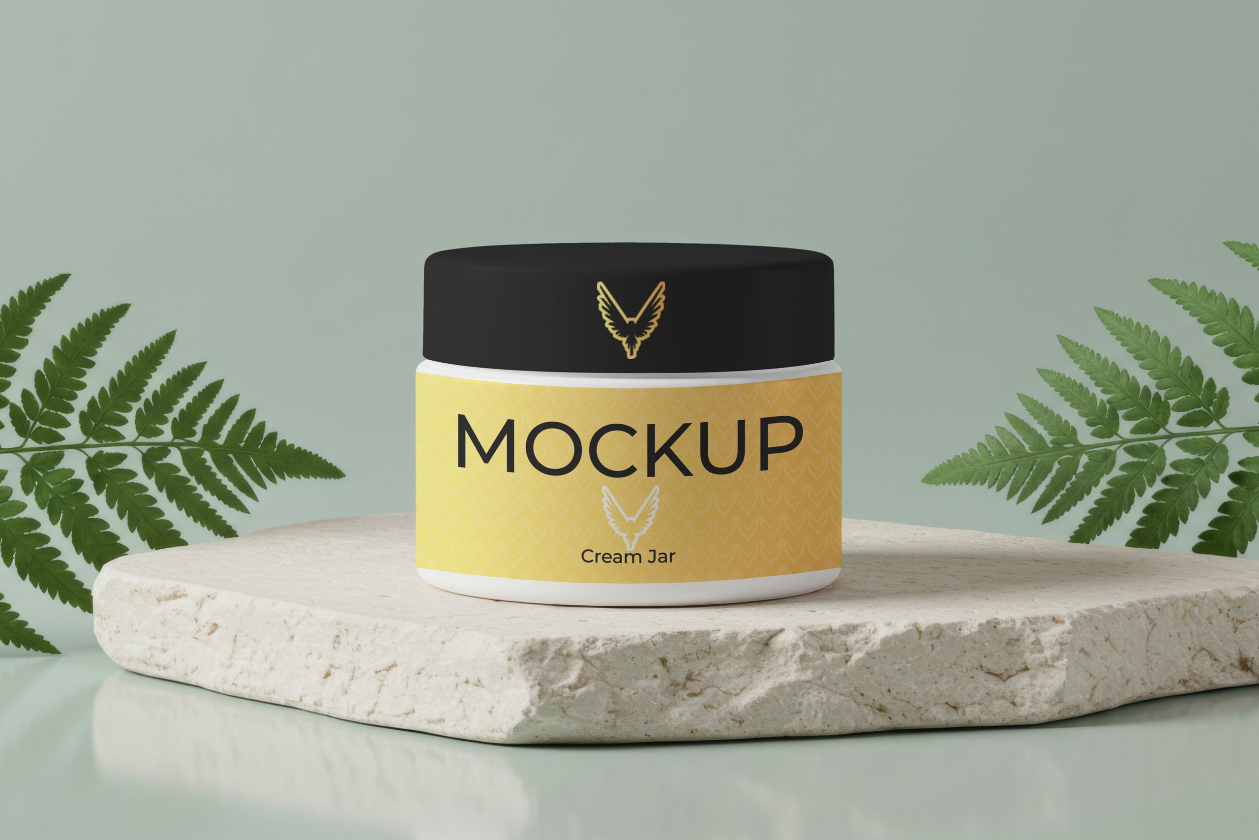 Free cream jar mockup on stone base with green ferns