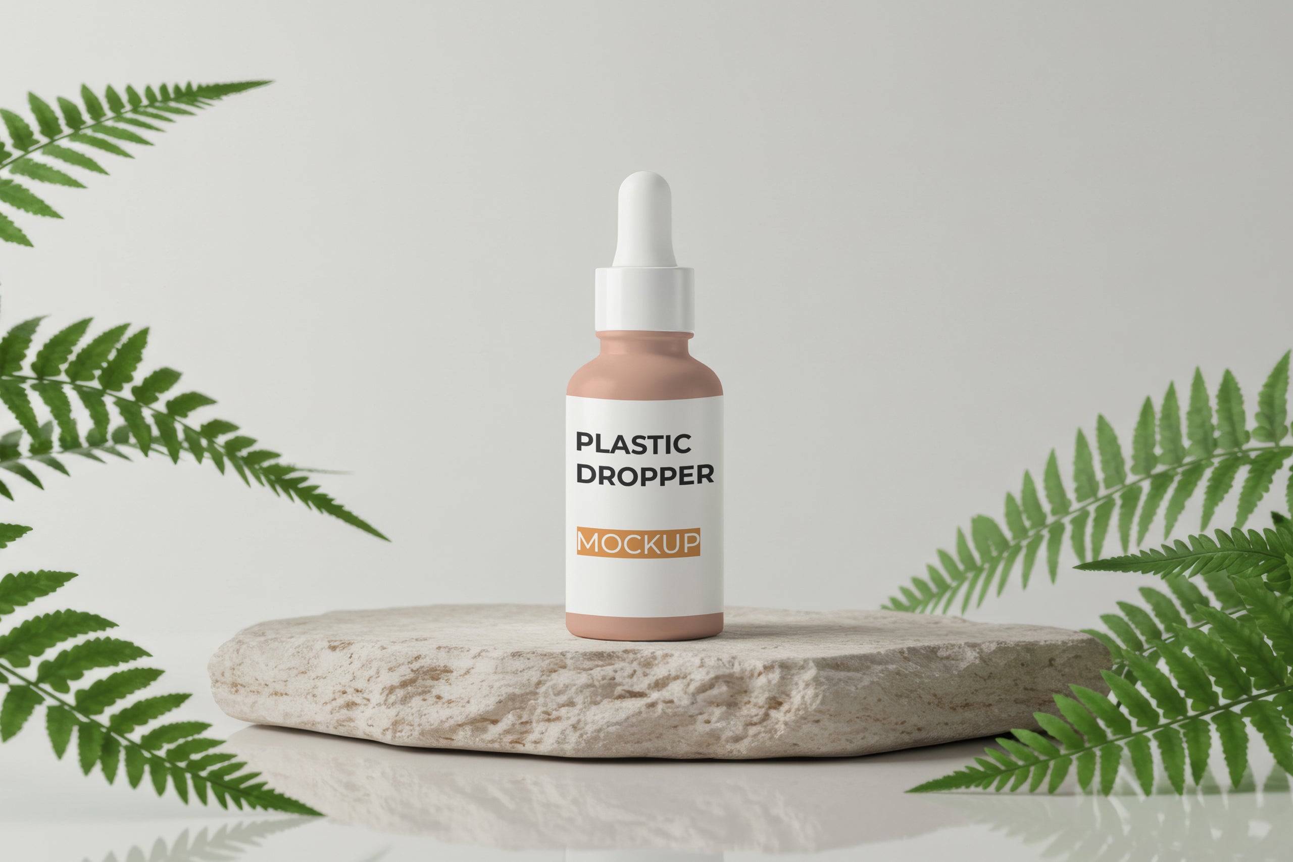 Free dropper bottle mockup on stone base with green leaves