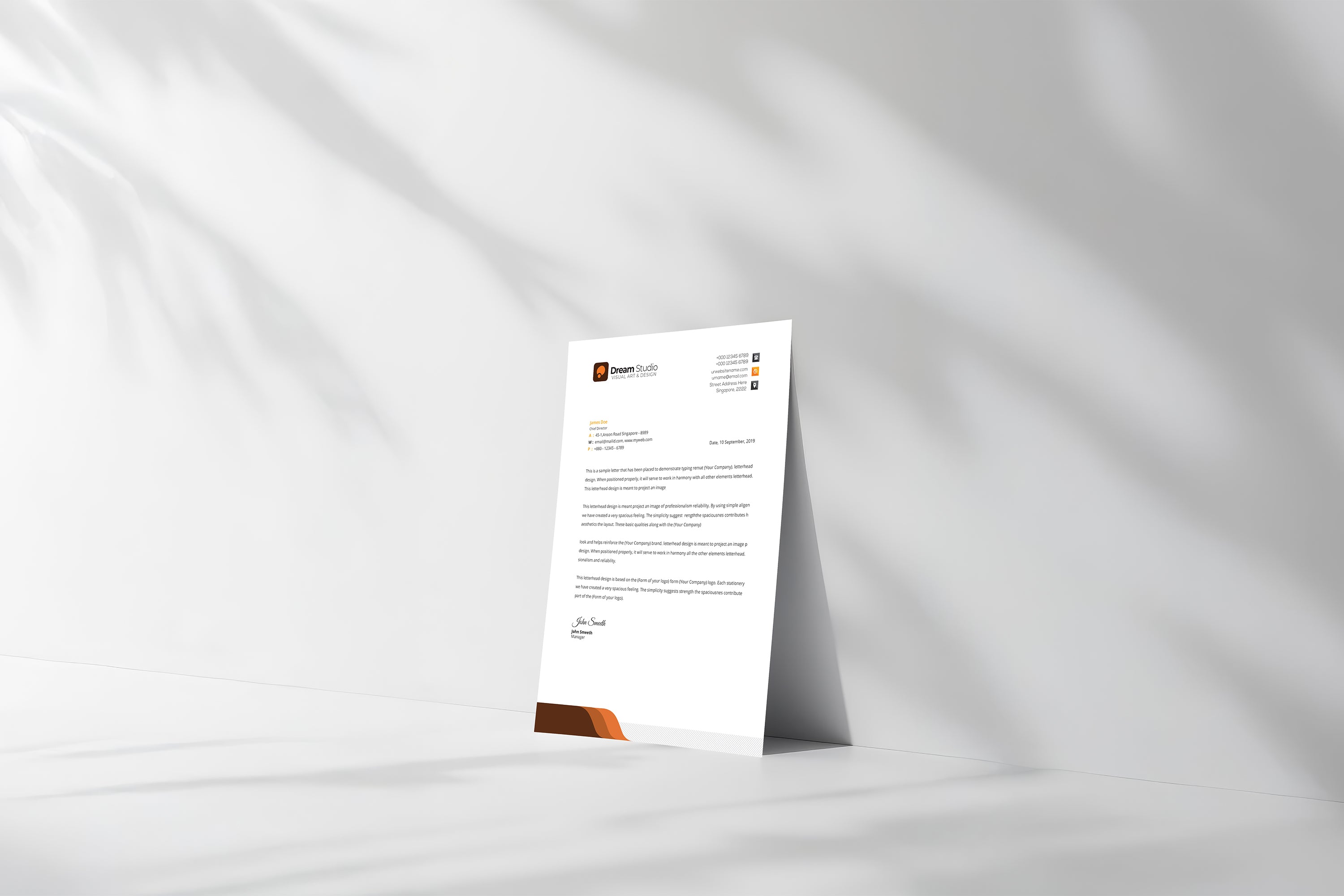 Free letterhead paper mockup standing on soft fabric background